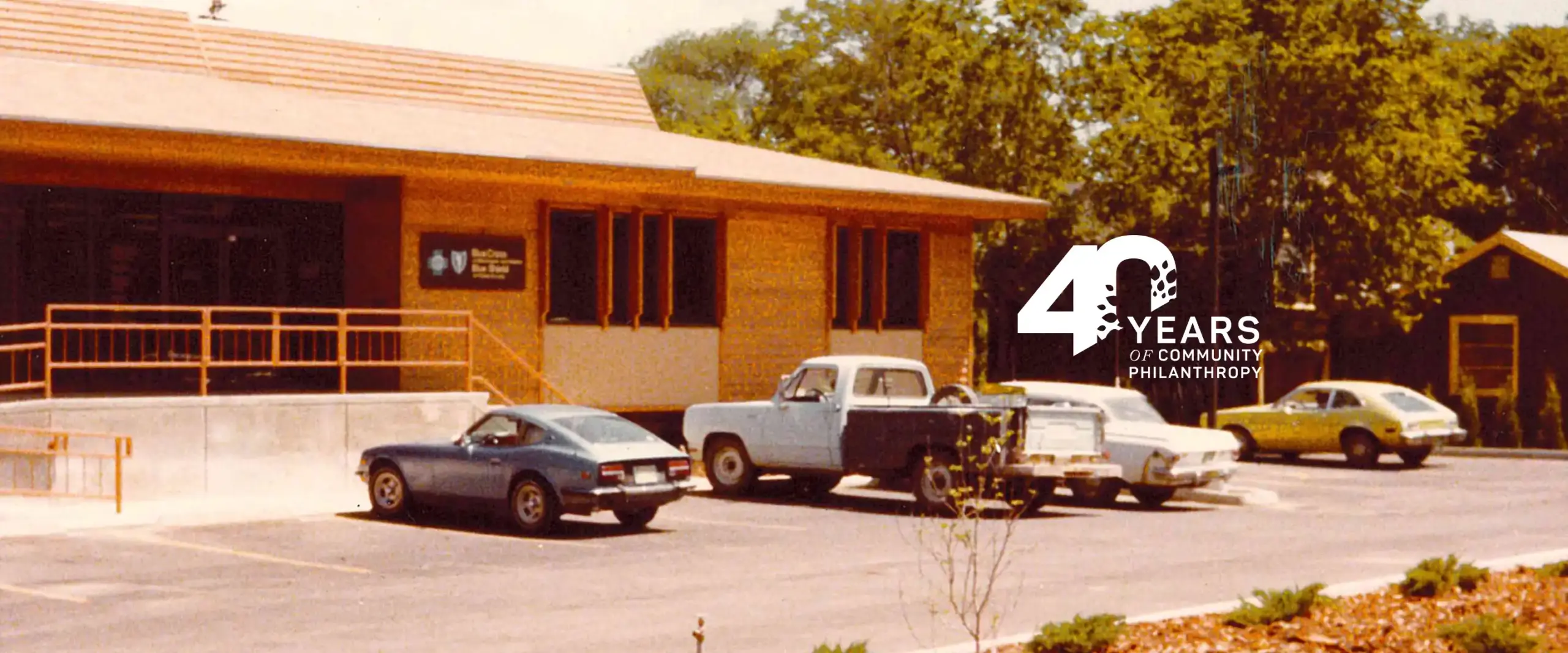 Archival scan of original CFNCW building from 1986 with cars parked out front